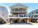 Two-story coastal home featuring dual balconies and covered parking at 6001-1010 S Kings Highway, Myrtle Beach, SC 29575