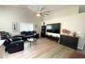 Living room featuring vaulted ceilings, modern fan, and sleek black entertainment center at 620 Bathurst Dr., Myrtle Beach, SC 29579