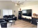 Spacious living room featuring vaulted ceilings, modern fan, and sleek entertainment center at 620 Bathurst Dr., Myrtle Beach, SC 29579