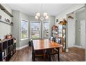 Bright dining room features a chandelier, bay window and an elegant display cabinet at 715 Hobonny Loop, Longs, SC 29568