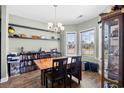 Dining room features dark wood floors and a chandelier; display cabinet and shelving at 715 Hobonny Loop, Longs, SC 29568