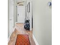Inviting entryway with wood floors, white door, welcome sign, and stylish runner rug at 715 Hobonny Loop, Longs, SC 29568