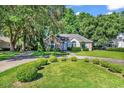 Beautiful single-story home with stone accents, mature trees, and manicured lawn at 765 Shaftesbury Ln., Conway, SC 29526