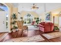 Bright living room boasts vaulted ceilings, hardwood floors, and a large arched window at 765 Shaftesbury Ln., Conway, SC 29526
