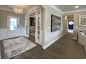 Inviting foyer with an elegant chandelier, hardwood floors, and access to multiple rooms at 121 Eagle Claw Dr., Carolina Shores, SC 28467