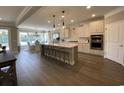 Spacious kitchen featuring a large island, pendant lighting, modern appliances, and an adjacent dining area at 121 Eagle Claw Dr., Carolina Shores, SC 28467