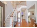 Bright foyer with hardwood floors, featuring a staircase and views into the living areas at 1427 Mcmaster Dr., Myrtle Beach, SC 29575
