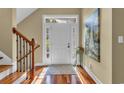 Welcoming foyer with hardwood floors, a white front door, and a painting, leading to a bright, inviting space at 154 Harbor Oaks Dr., Myrtle Beach, SC 29588