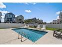 Backyard pool with lounge chairs and a white privacy fence at 221 N Waccamaw Dr., Murrells Inlet, SC 29576