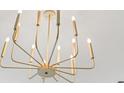 Close up of a modern, gold light fixture with twelve lights at 2241 Sand Dunes Dr., Myrtle Beach, SC 29577