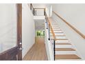 Bright foyer with wooden stairs and wood floors leading into the living space at 2241 Sand Dunes Dr., Myrtle Beach, SC 29577