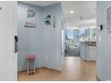 Charming entryway with beach-themed decor, opening to kitchen and living area with ocean views at 300 N Ocean Blvd. # 128, North Myrtle Beach, SC 29582