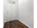 Bright entryway featuring sleek wood floors and a modern white door at 4051 Mclamb Ave. # 4051, Little River, SC 29566