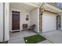 Inviting front porch featuring outdoor seating, adjacent to a well-maintained garage and stone facade accents at 4051 Mclamb Ave. # 4051, Little River, SC 29566