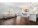 Open living area with hardwood floors, leading to a dining space and kitchen with bright natural light at 4051 Mclamb Ave. # 4051, Little River, SC 29566