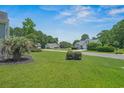 Attractive single-story home with a spacious lawn, mature trees, and a paved driveway at 4539 Fringetree Dr., Murrells Inlet, SC 29576