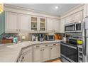 Well-maintained kitchen boasts modern stainless appliances, ample cabinet space, and mosaic backsplash at 517 S Ocean Blvd. # 705, North Myrtle Beach, SC 29582
