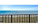 Balcony view showcases a sandy beach and beautiful oceanfront panorama at 517 S Ocean Blvd. # 705, North Myrtle Beach, SC 29582