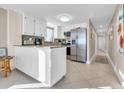 Bright kitchen with white cabinets, granite countertops, and stainless steel appliances at 5910 N Ocean Blvd. # 504, North Myrtle Beach, SC 29582
