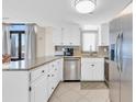 Well-lit kitchen featuring stainless steel appliances, white cabinets and a granite counter at 5910 N Ocean Blvd. # 504, North Myrtle Beach, SC 29582