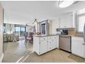Open kitchen with granite countertops that flows into a spacious living area with ocean views at 5910 N Ocean Blvd. # 504, North Myrtle Beach, SC 29582