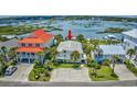 Aerial view of waterfront home boasting lovely landscaping, a driveway, and serene views of the water at 624 Dogwood Dr. S, Garden City Beach, SC 29576