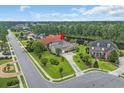 Aerial view of a suburban home with a backyard bordering a pond, surrounded by lush greenery at 8013 Wacobee Dr., Myrtle Beach, SC 29579