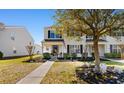 Charming two-story home with an American flag, mature landscaping, and a sidewalk at 864 Barn Owl Ct. # 864, Myrtle Beach, SC 29579