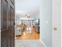 View into the living room with hardwood floors, comfortable furniture, and a TV at 864 Barn Owl Ct. # 864, Myrtle Beach, SC 29579