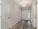 Inviting entryway featuring wood-look flooring, a white front door with sidelights, and neutral paint at 1004 Woodside Dr., Conway, SC 29526