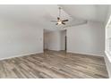 Spacious living room featuring wood-look flooring, vaulted ceiling, and a ceiling fan at 1004 Woodside Dr., Conway, SC 29526
