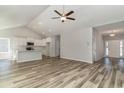 Open-concept living room, showcasing the kitchen, vaulted ceiling, and durable wood-look flooring at 1004 Woodside Dr., Conway, SC 29526