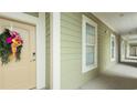 Exterior hallway featuring neutral paint, adjacent windows, and a decorative wreath on front door at 130 Puffin Dr. # 2B, Pawleys Island, SC 29585