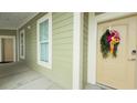 Exterior hallway with adjacent windows, neutral paint, and a wreath on front door at 130 Puffin Dr. # 2B, Pawleys Island, SC 29585