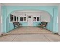 Charming covered porch featuring seating and a well-designed drainage system for added convenience at 1885 Pompano Dr., Garden City Beach, SC 29576