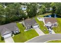 A high angle view showcases the house, the neighborhood, and the nearby pond at 216 Palm Terrace Loop, Conway, SC 29526