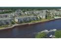 Aerial view of waterfront condos with boaters, a pool, and mature landscaping at 2180 Waterview Dr. # 721, North Myrtle Beach, SC 29582