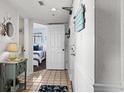 Hallway with tiled flooring, nautical themed decorations, and bedroom access at 2501 S Ocean Blvd. # 508, North Myrtle Beach, SC 29582