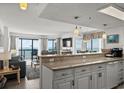 Modern kitchen featuring counter seating open to the living room and ocean views at 2501 S Ocean Blvd. # 508, North Myrtle Beach, SC 29582