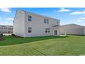 Spacious backyard with lush green lawn and covered patio, perfect for outdoor entertaining at 3530 Ashridge Way, Conway, SC 29526