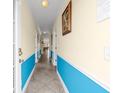 Hallway with cream colored walls and stylish blue wainscoting that accentuates the space at 817 S Ocean Blvd. # 201, North Myrtle Beach, SC 29582