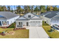 Charming single-story white home with a two-car garage and well-maintained landscaping at 546 Beckham Ct., Murrells Inlet, SC 29576