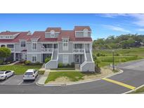 Charming townhomes featuring covered entrances, well-maintained landscaping, and convenient parking at 4396 Baldwin Ave. # 47, Little River, SC 29566