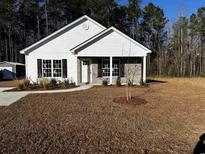 New construction home with white siding and brick accents at 3157 Bryant St., Loris, SC 29569