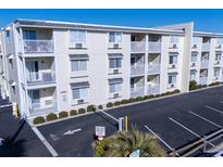 Three-story building with parking and gated access at 6305 N Ocean Blvd. # B-3, North Myrtle Beach, SC 29582