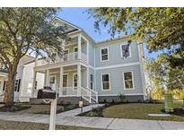 Charming two-story light blue home with double porches and lush landscaping at 1604 James Island Ave., North Myrtle Beach, SC 29582