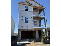 New construction home features a three story design with a garage, ready for finishing touches at 1207 Salt Windy Way, North Myrtle Beach, SC 29582
