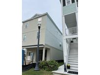 Charming two-story exterior showcases a light-colored siding and covered entryway at 1310 Battery Park Dr., North Myrtle Beach, SC 29582