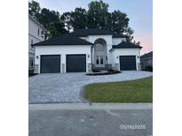 Stunning home features a paved driveway and 3-car garage, enhanced by lush landscaping and a modern design at 2204 Via Palma Dr., North Myrtle Beach, SC 29582