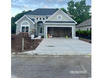 Charming single-story home featuring a stone accent wall and an attached two-car garage at 5508 Via Verde Dr., North Myrtle Beach, SC 29582